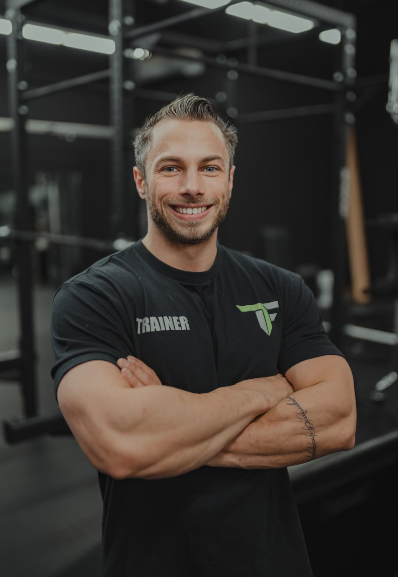 Chris, personal trainer and coach, standing in a gym